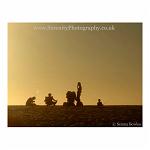Sunset on the beach; a group of friends sit around fishing and relaxing. KAlbarri, Australia.